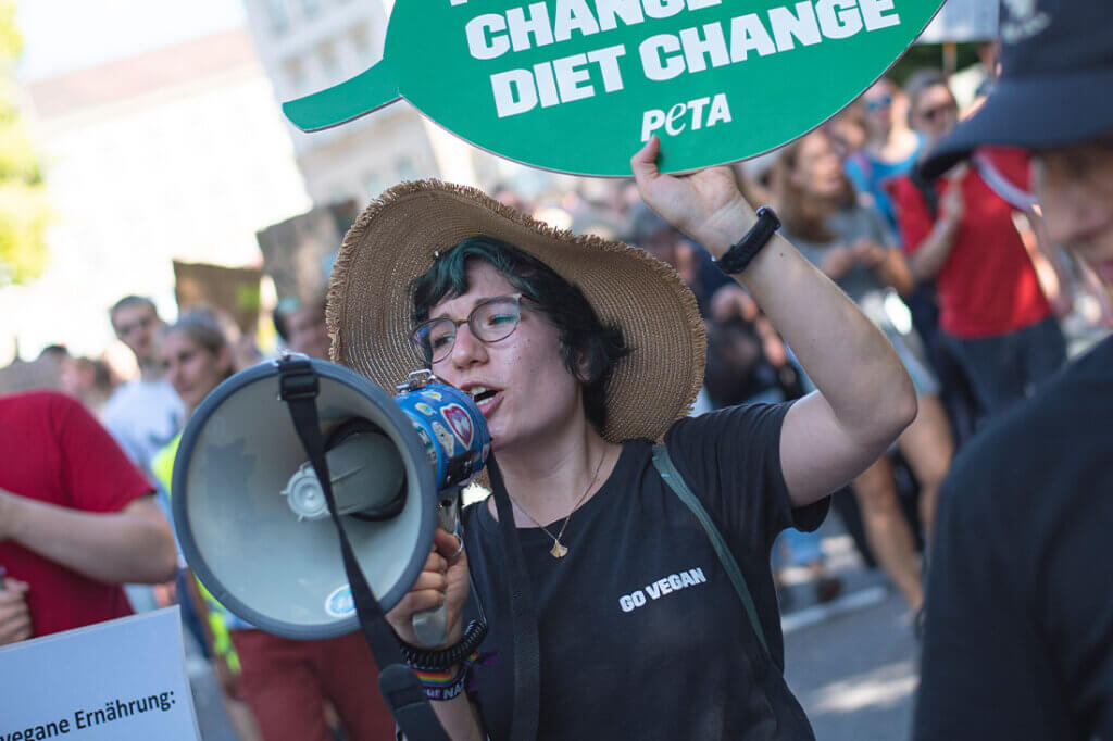 PETA Streetteam Demo. Frau mit Megafon.